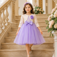 Young girl in a purple dress with a floral headband standing on a staircase.