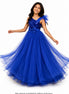 Woman wearing a blue evening gown with a bow detail on a white background