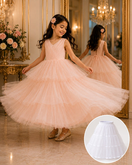 Young girl in a pink dress twirling in a grand room with chandeliers and floral arrangements.