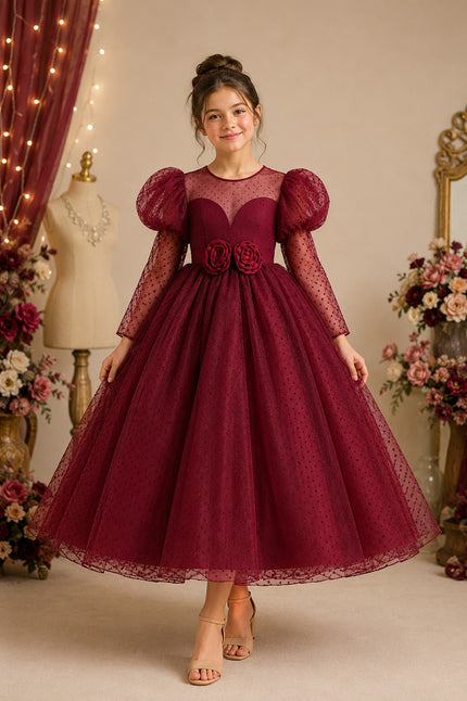 Woman wearing a burgundy lace dress with puff sleeves in a decorated room.