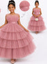 Young girl wearing a pink tiered dress with a close-up of the fabric and a measurement chart.