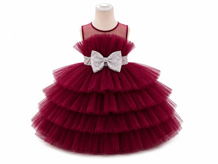 Red tiered dress with a silver bow on a mannequin against a white background