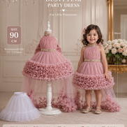 Dusty pink party dress for young girls with a matching dress form in a decorative room.