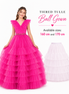 Pink tiered tulle ball gown with a smaller white version on a white background