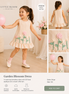 Child wearing a 'Garden Blossom Dress' from the Little Bloom Collection with floral appliqués.